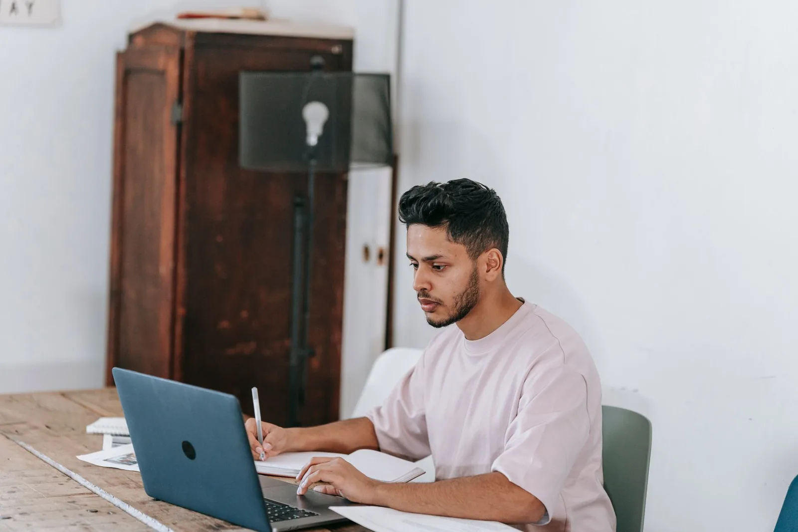 Person at a laptop comparing the ChatGPT Go and ChatGPT Plus subscription plans