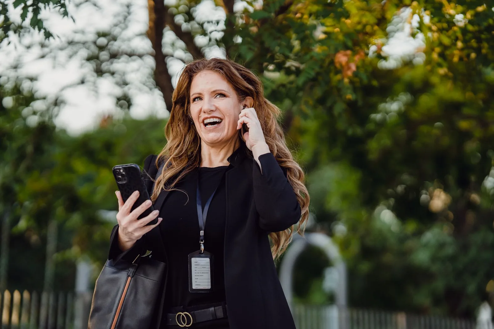 Person talking to a voice assistant on a smartphone while walking