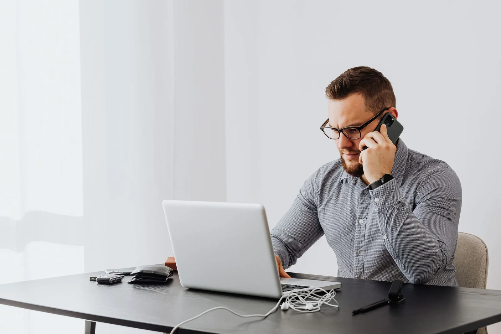 Person weighing a monthly subscription cost at a desk