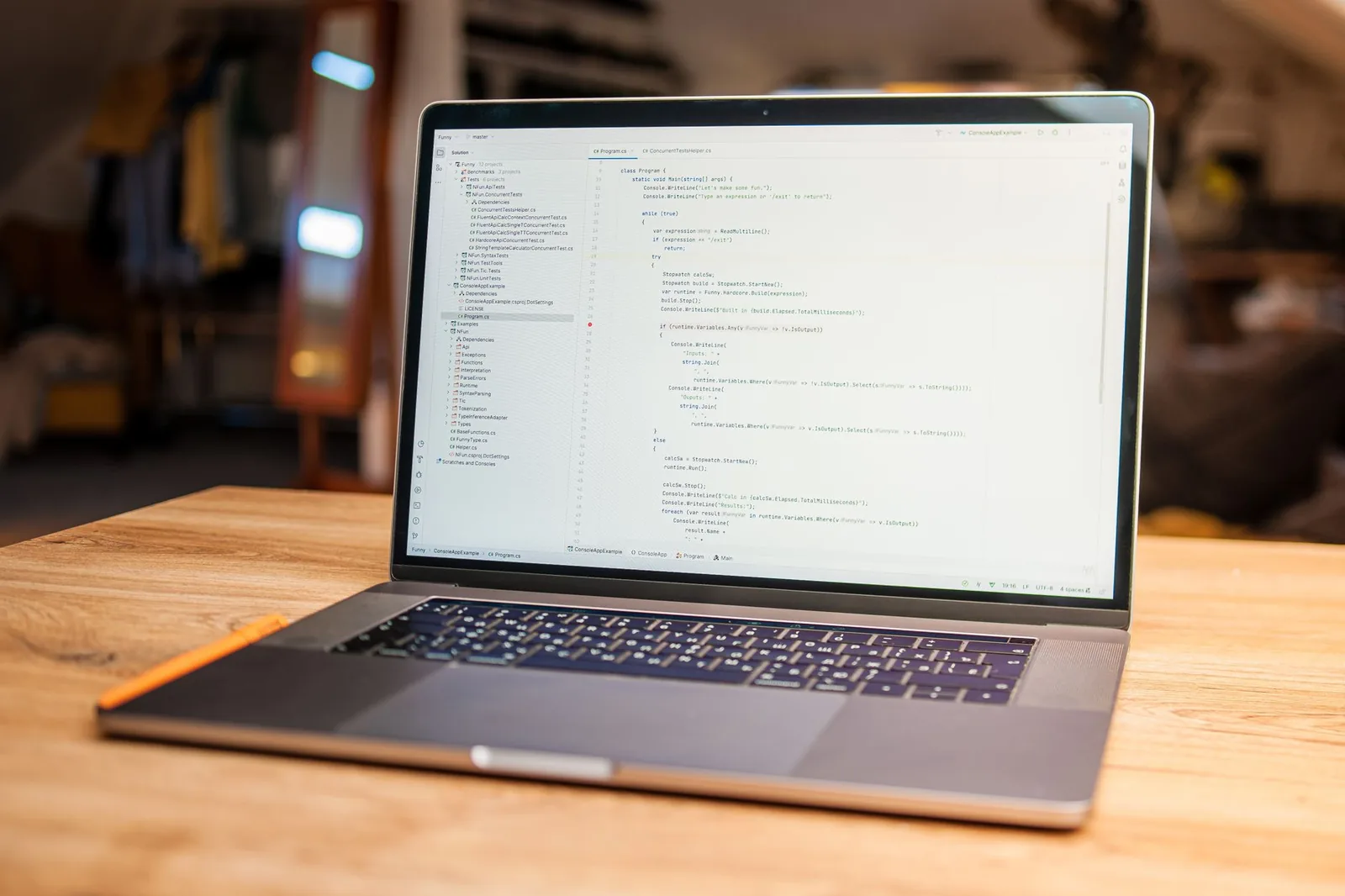 Developer working in a code editor on a laptop, deciding whether to pay for Claude Code