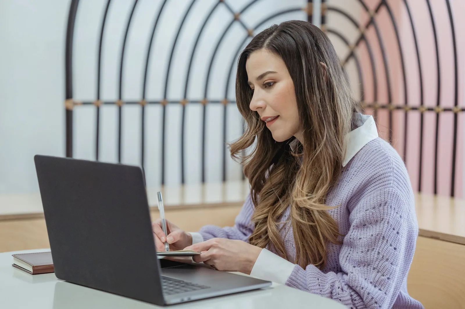 Person comparing Claude Opus 5.5 vs Sonnet 5.5 on a laptop